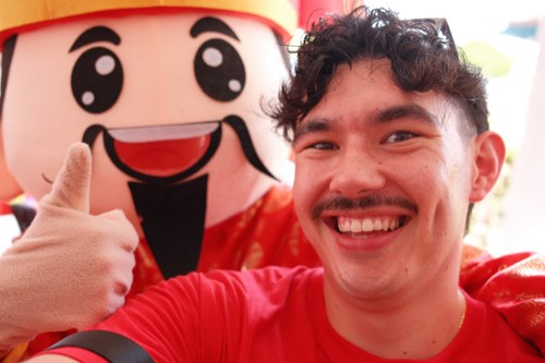 Adrian with a mascot
