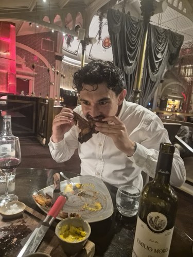 Adrian tucking into a steak dinner